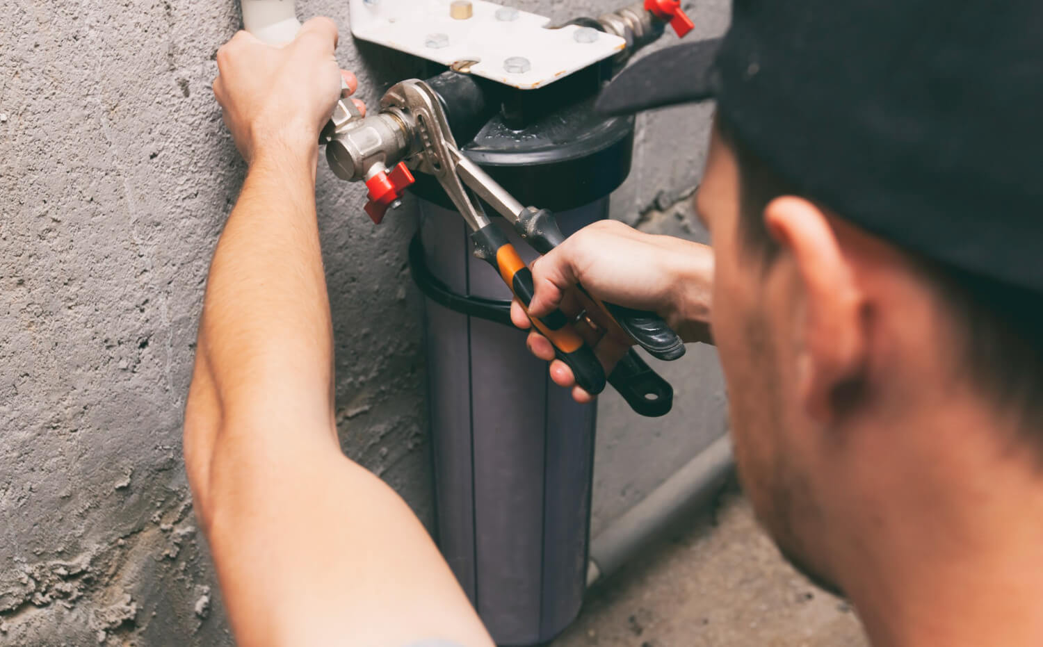plumber-repairing-water-filter-basement (1)